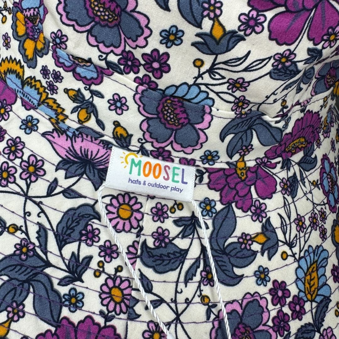 Girls Purple Flowers Print Bucket Hat. Extra wide brim for sun protection. UPF50+ Adjustable strap for windy days.