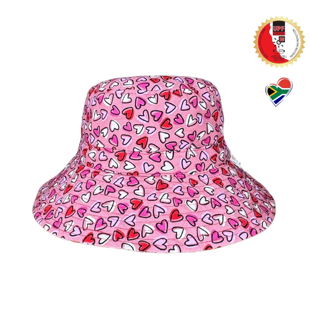 Girls Pink Hearts Print Bucket Hat. Extra wide brim for sun protection. UPF50+ Adjustable strap.