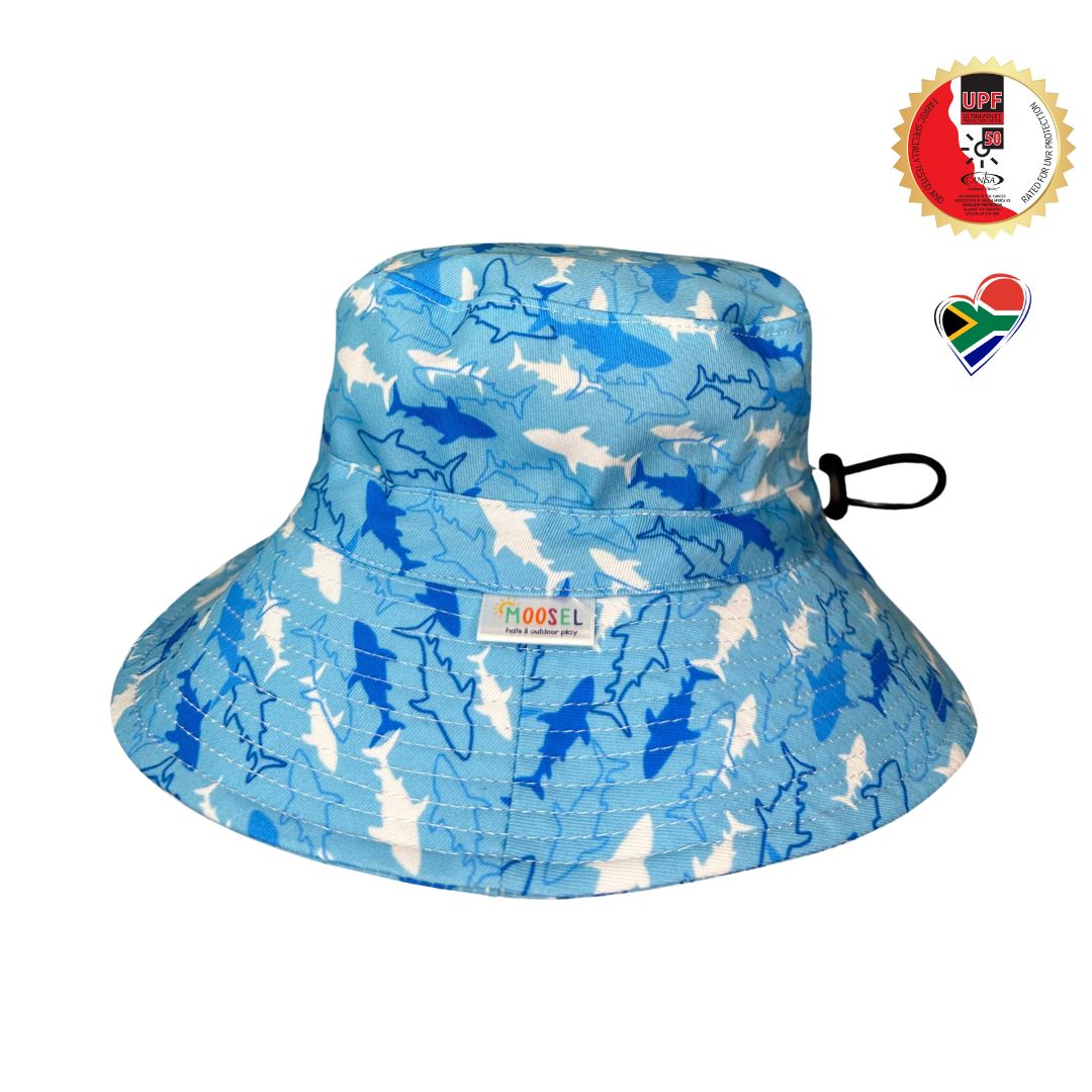 Boys Blue fabric with Blue sharks Print Bucket Hat. Extra wide brim for sun protection. UPF50+ Adjustable strap.