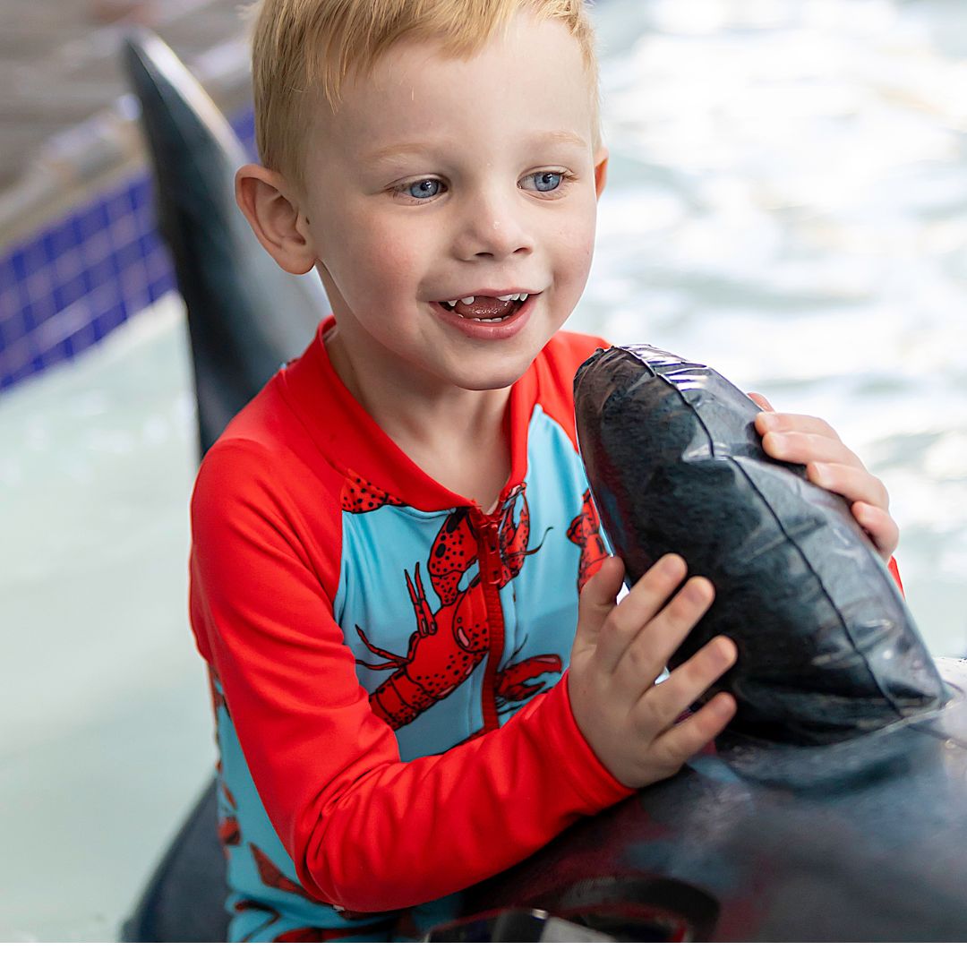 Boys blue & red Onesie in bright vibrant colours. Long sleeves, high neck cover. UPF50+ certified. Front zip. Dermatologist approved