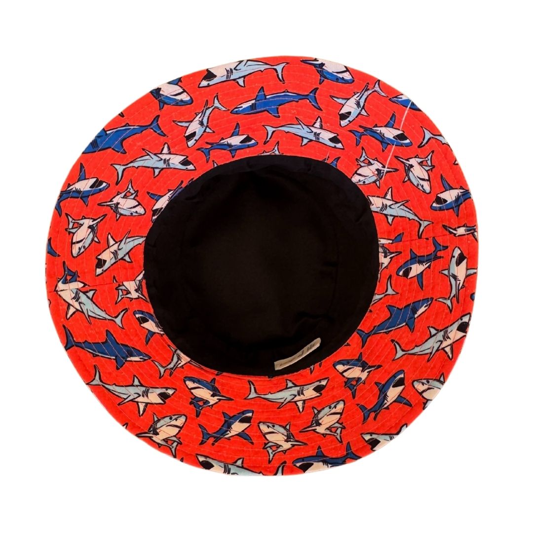 Boys Orange Fabric with Blue Sharks Print Bucket Hat. Extra wide brim for sun protection. UPF50+ Adjustable strap for windy days. 